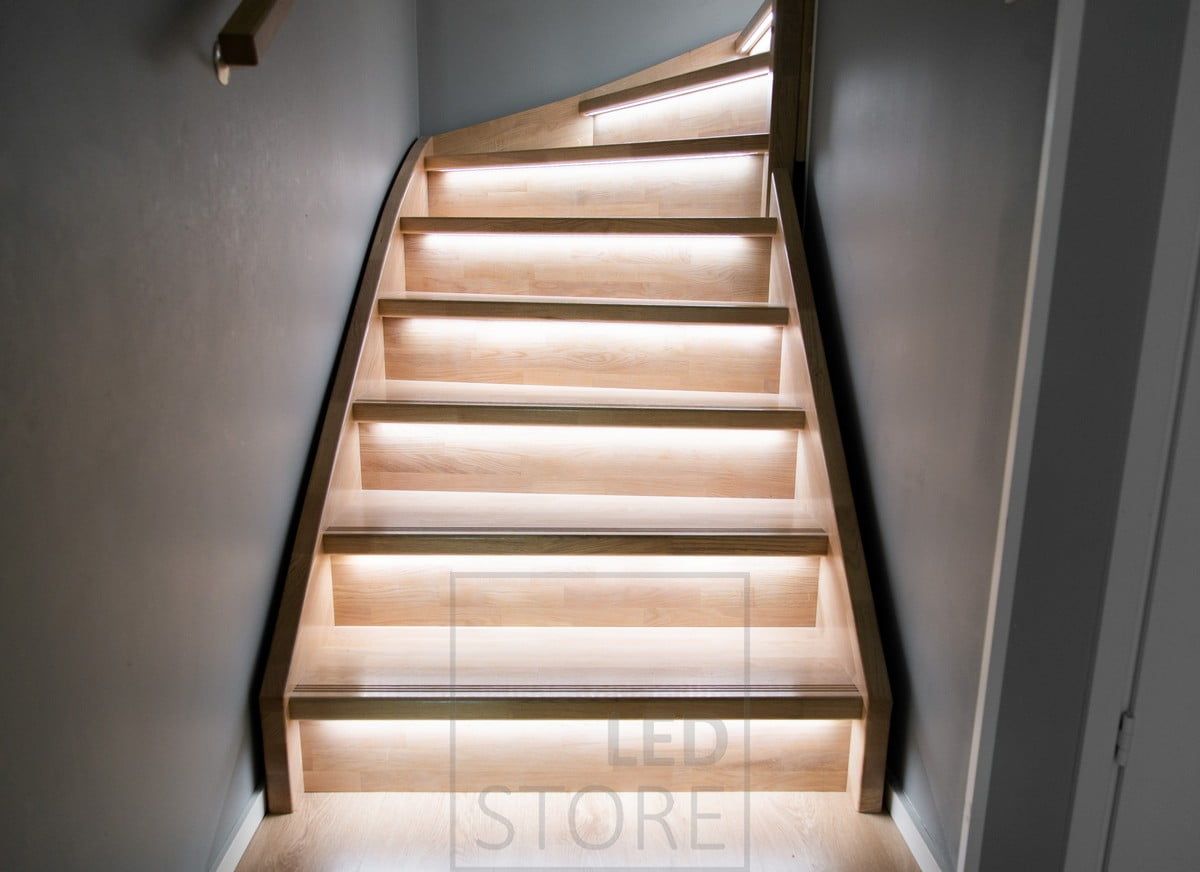 LED strips on the staircase lip illuminating the steps downwards with indirect light.